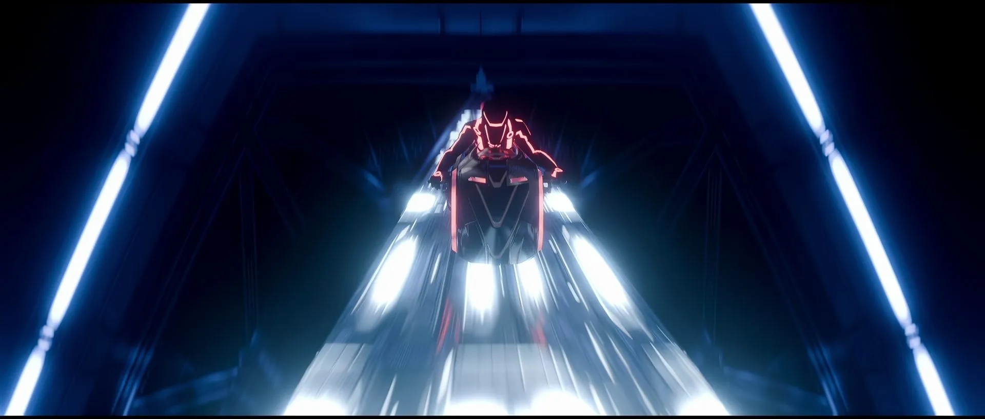 A rider in a red-lit suit races a light cycle head-on through a dark hexagonal tunnel framed by blue neon strips.
