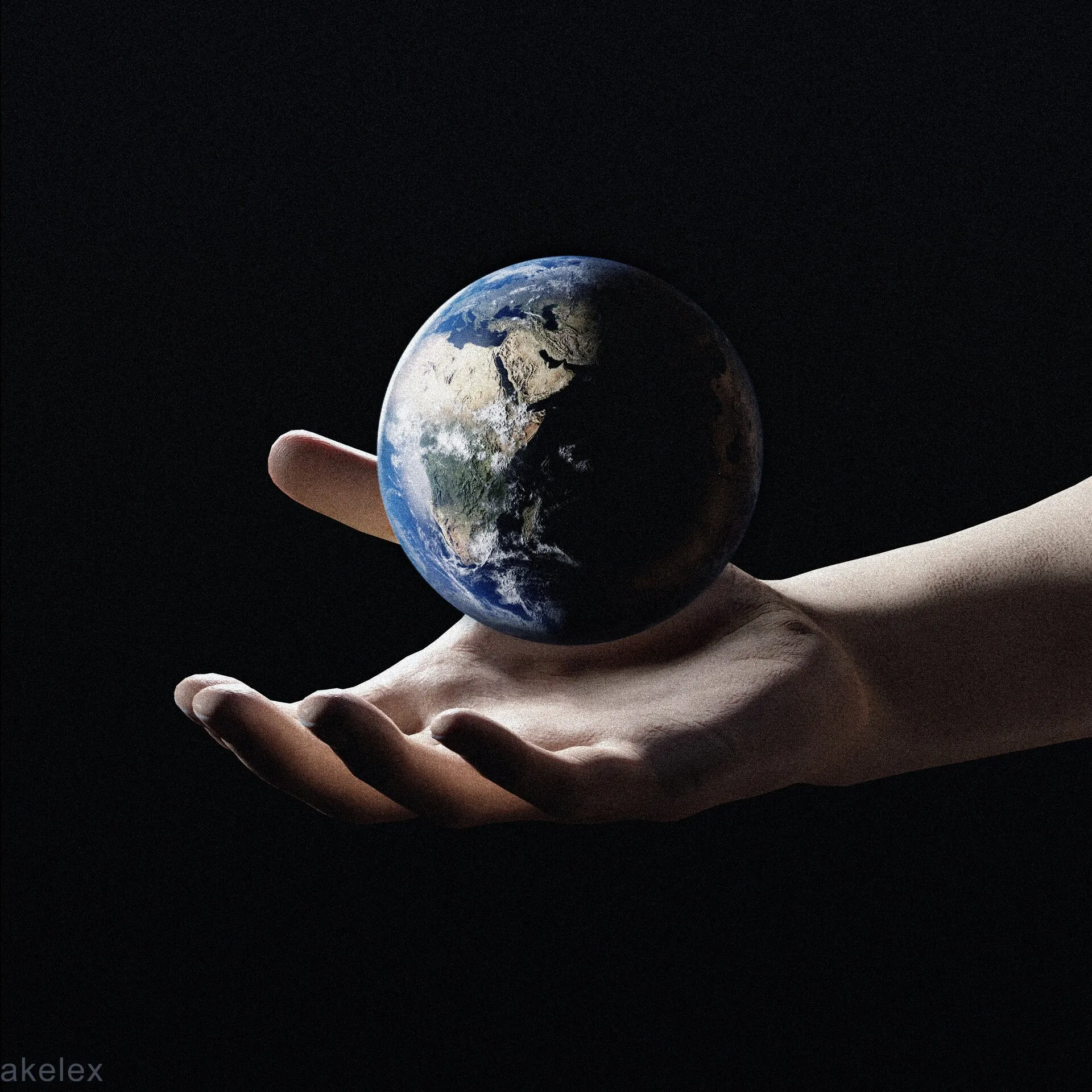 A realistic planet Earth, half in shadow, floats just above an open outstretched human hand against a completely black background.