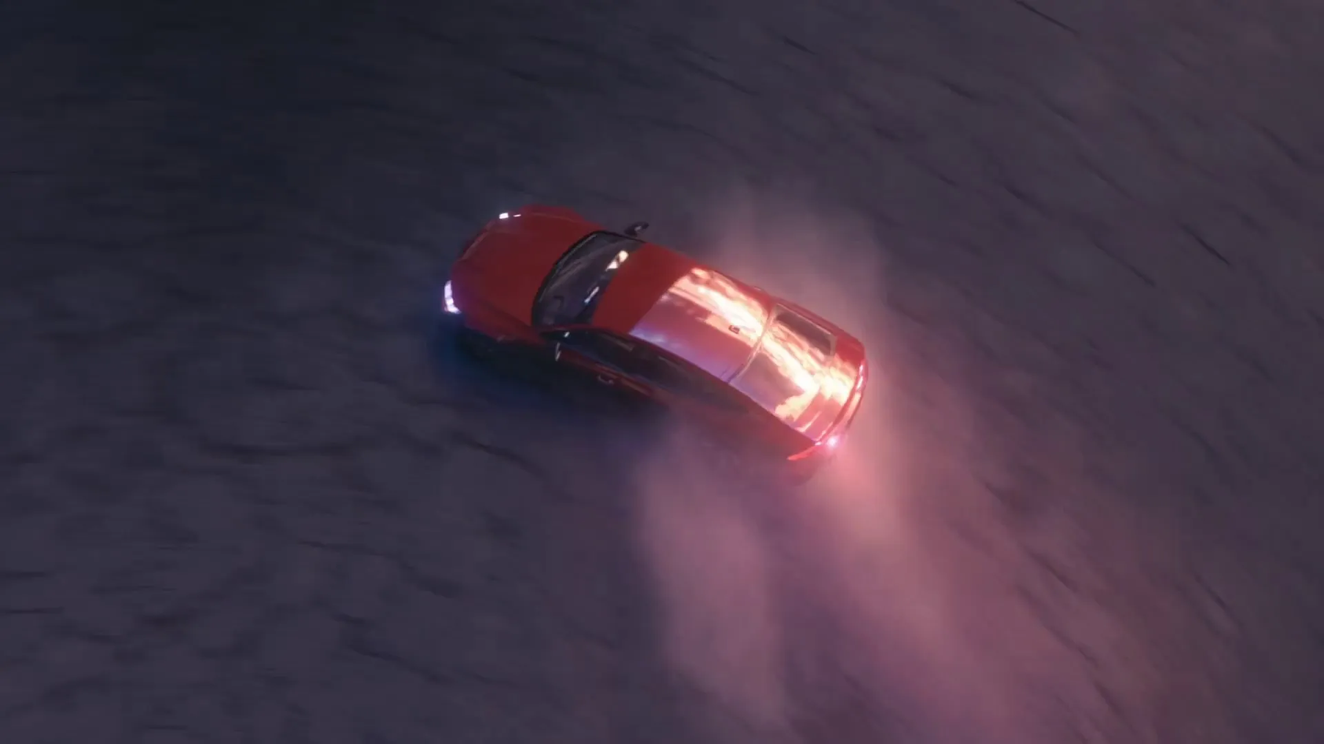 Top-down drone view of the Audi drifting with a long smoke trail.