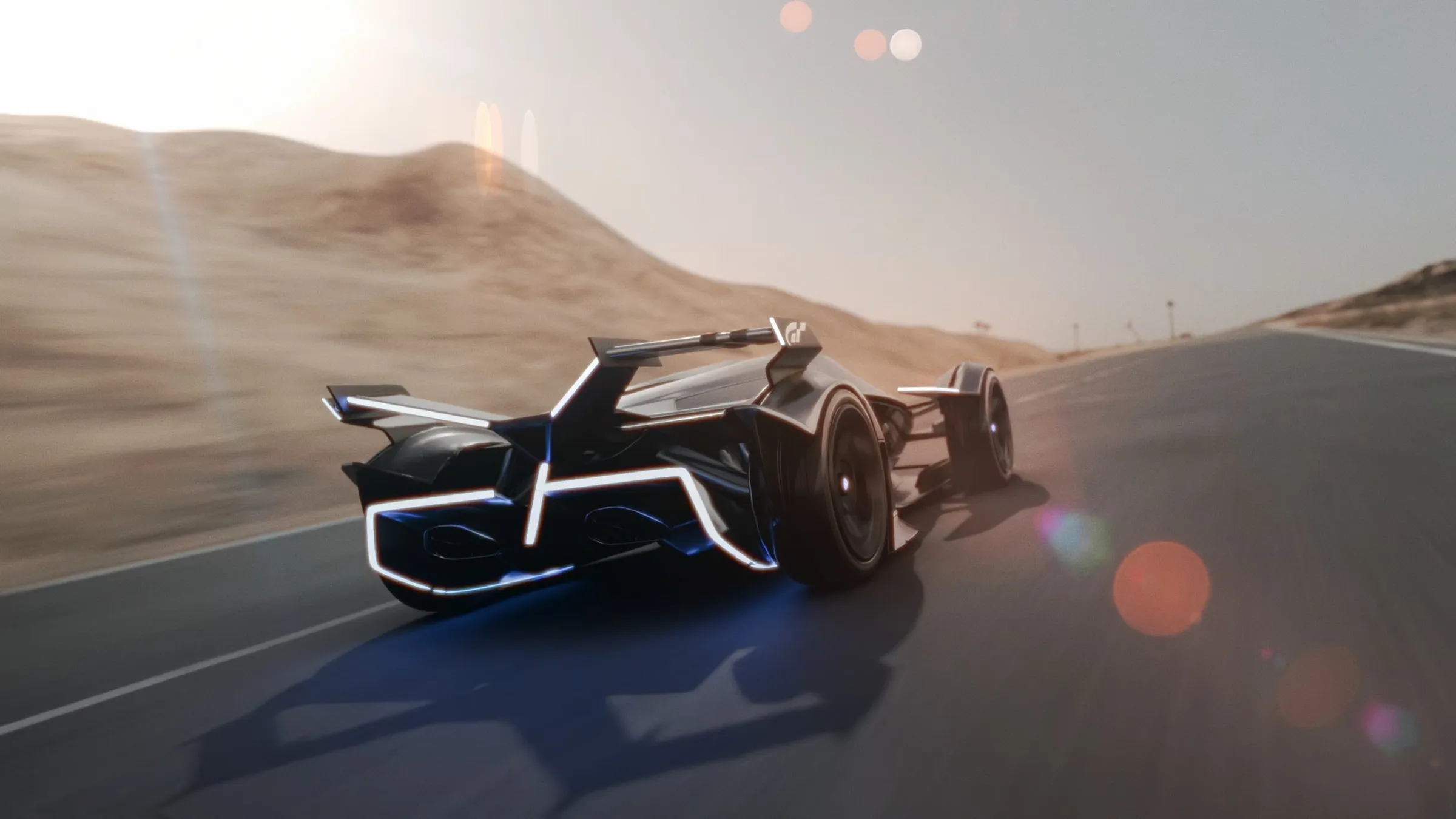 Rear chase view of the Lamborghini on a desert highway with dust and low sun.